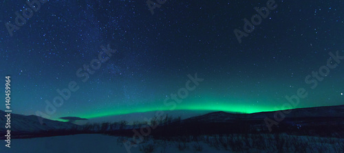 Panorama with Milky way and Northen lights Aurora. © Modella