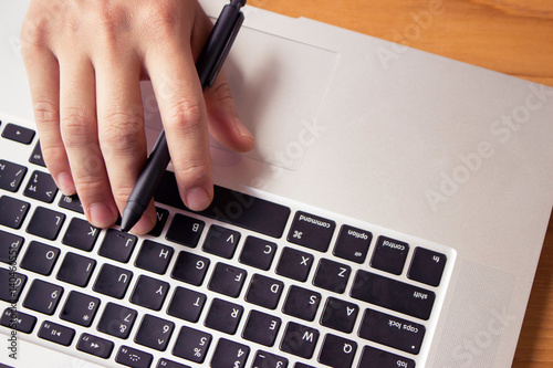 Photos man working at home office hand on keyboard close up