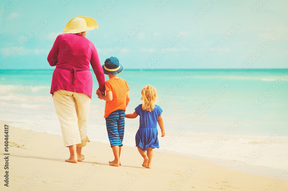 Happy grandmother with kids- little boy and girl- at beach Happy grandmother with kids- little boy and girl- at beach