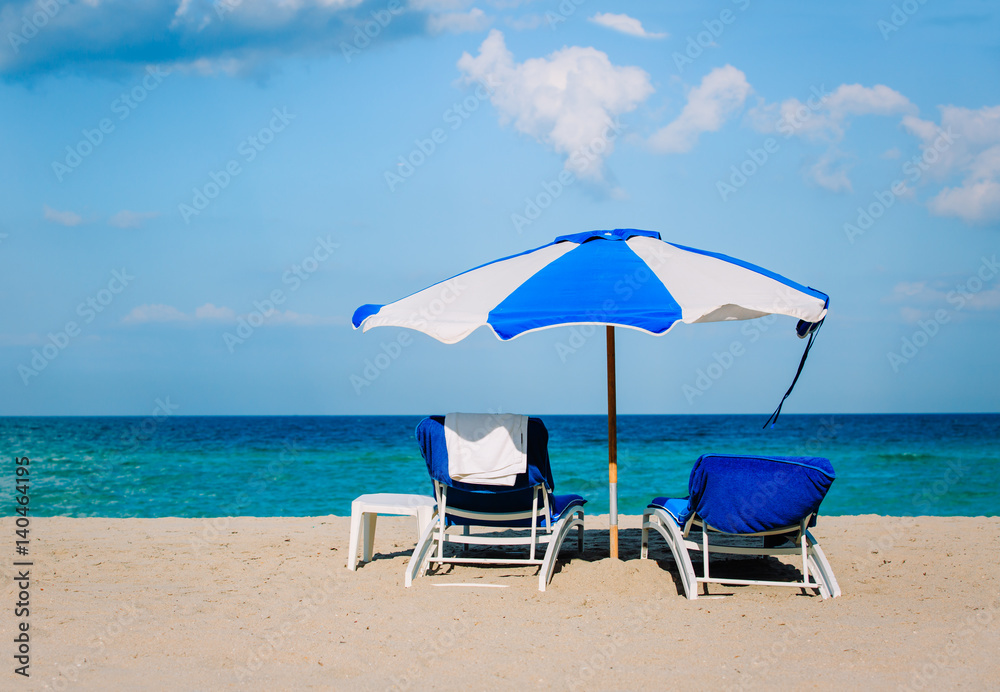 chairs on tropical sand beach