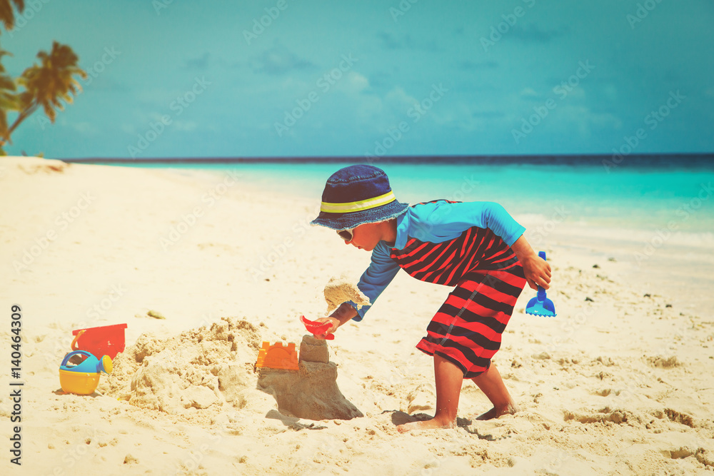 little boy play with sand on beach little boy play with sand on beach