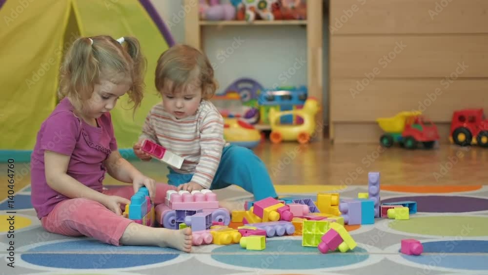 Boy and Girl Build Toy . Children Kid and Baby Play With Blocks. Educational Toys for preschool and kindergarten child. Brother and Sister Playing Boy and Girl Build Toy . Children Kid and Baby Play With Blocks. Educational Toys for preschool and kindergarten child. Brother and Sister Playing