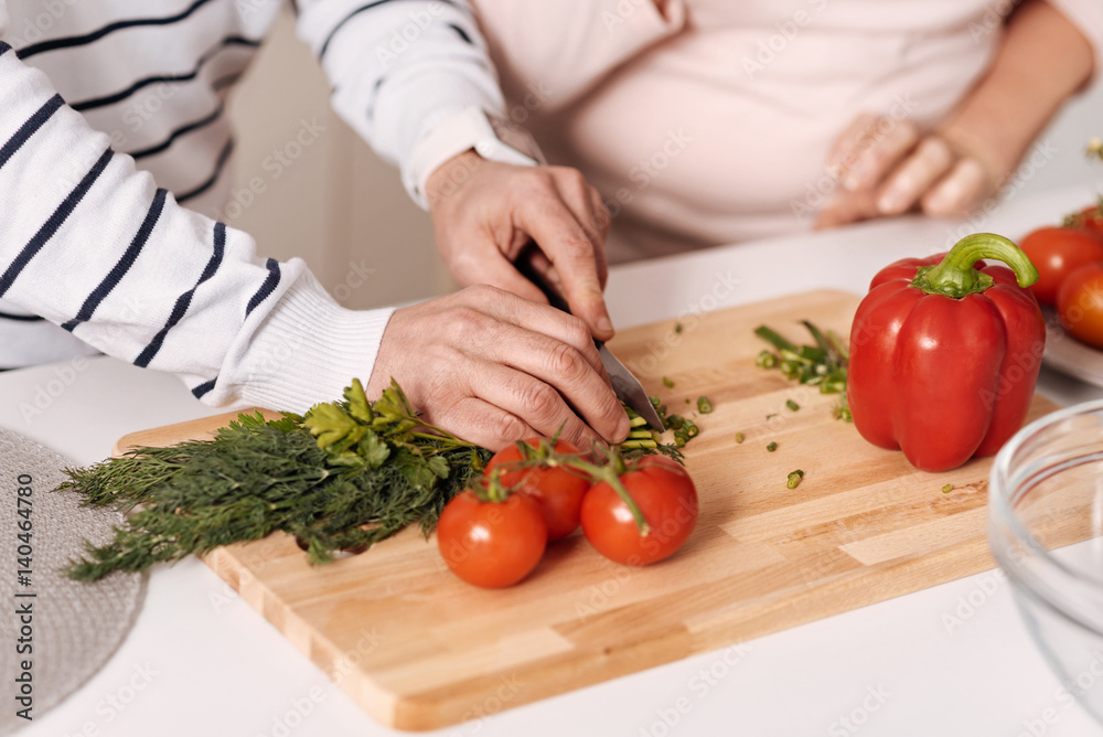 Senior couple preparing healthy dinner in the kitchen Senior couple preparing healthy dinner in the kitchen