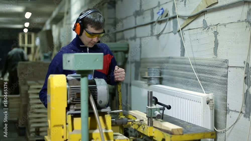Carpenter drilling holes in dash with bench drill