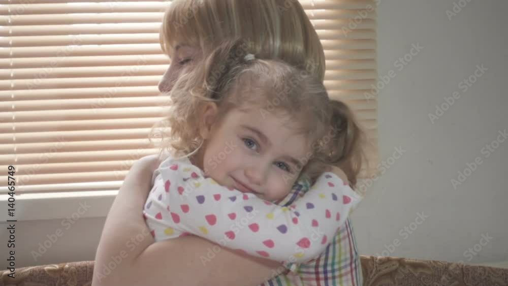 Daughter Rushes Into Mother's Arms At Home Across From the Window. Slow motion. Big Hug Daughter Rushes Into Mother's Arms At Home Across From the Window. Slow motion. Big Hug
