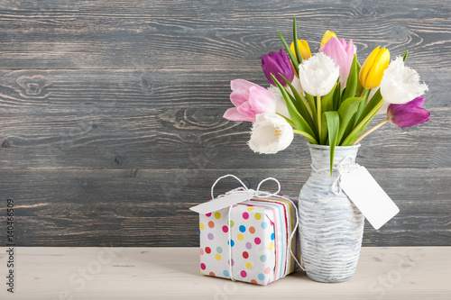 Gift box, colorful tulips in jug