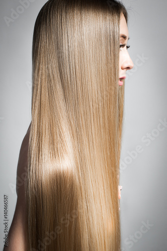 Very long beautiful shiny hair. Portrait of a blonde with long straight hair