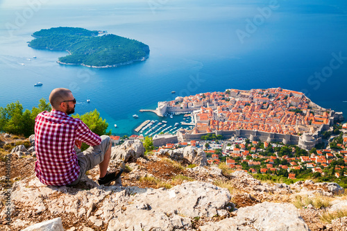 tourist man looking down to the Old Town of Dubrovnik photo