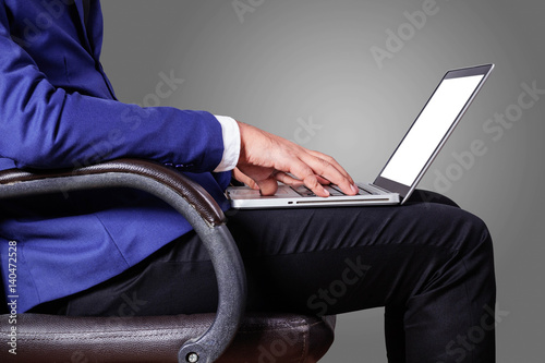 man with a laptop sitting in office.
