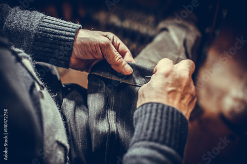 Tailor sewing some fabric
