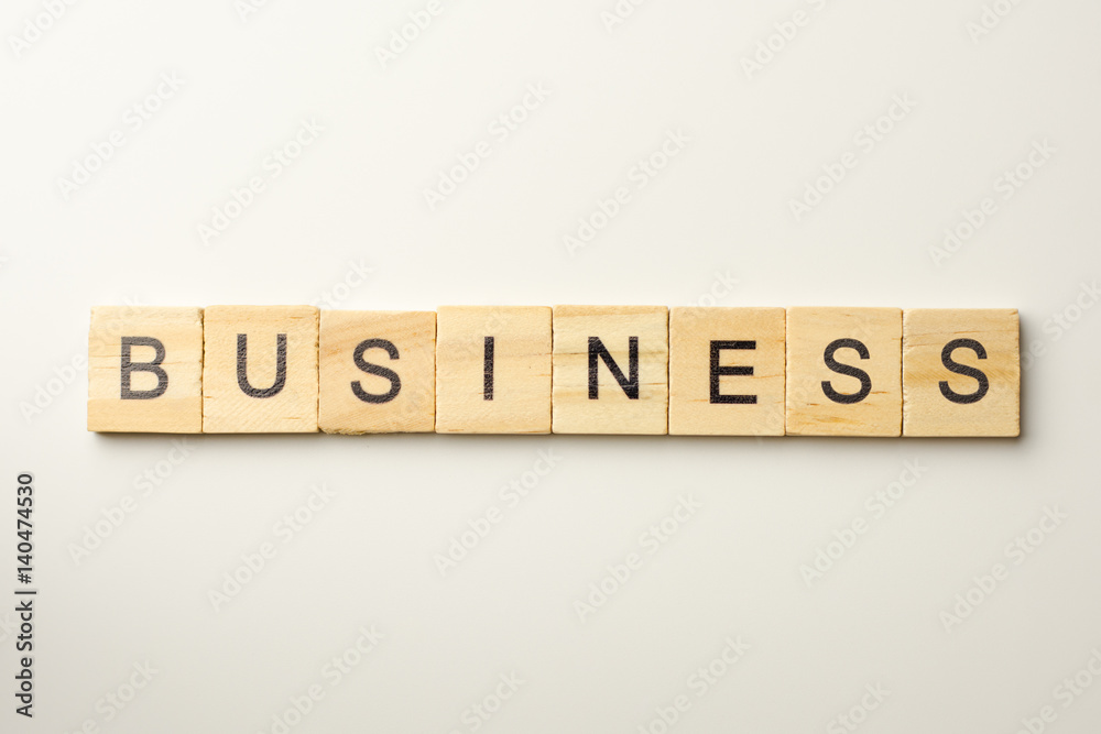 Text wooden blocks spelling the word BUSINESS on white background Text wooden blocks spelling the word BUSINESS on white background