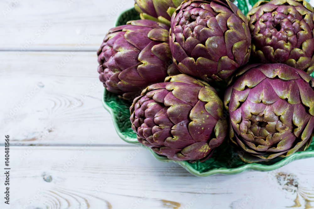Obraz premium Fresh big Romanesco artichokes green-purple flower heads ready to cook