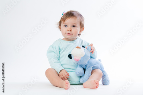 Portrait of a smiling child with a toy bear, isolated on a white background