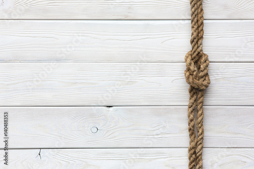 Fototapeta Naklejka Na Ścianę i Meble -  White wooden background, ship rope, sea knot, ship deck