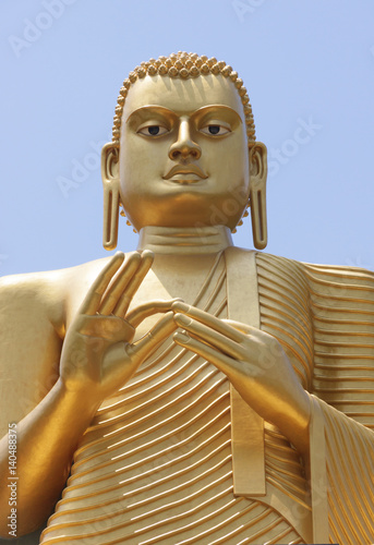 Statue of golden buddha in golden temple Dambulla, Sri Lanks, close view