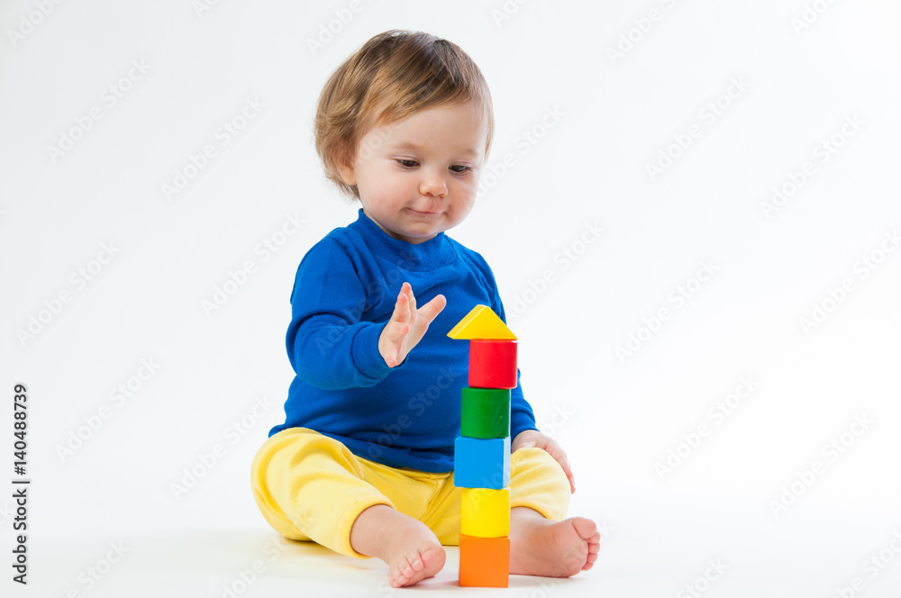 Little child playing with dices isolated on white background Little child playing with dices isolated on white background