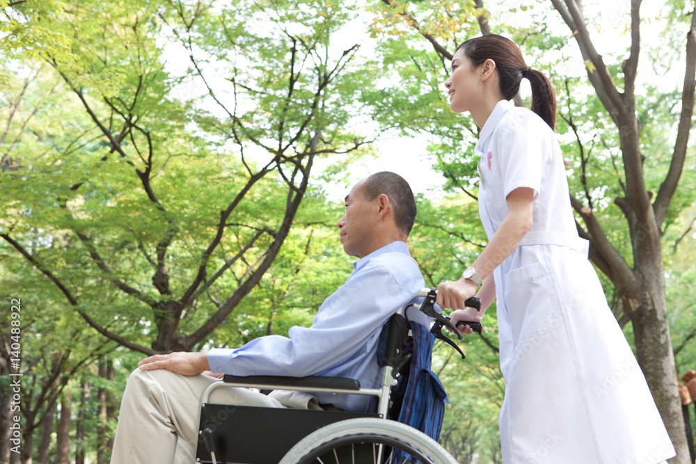 Nurse pushing man on wheelchair Nurse pushing man on wheelchair