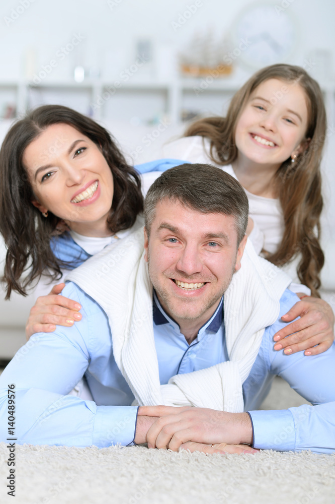 Happy family with daughter lie embracing Happy family with daughter lie embracing