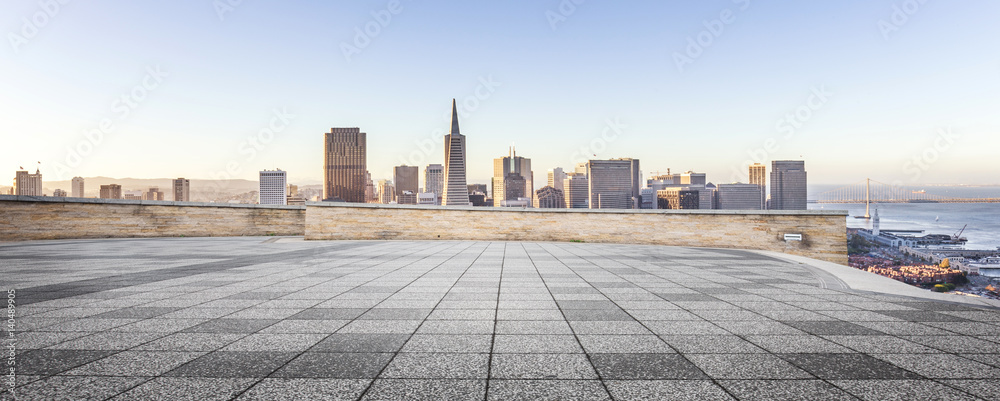 empty floor and modern city in sunny sky
