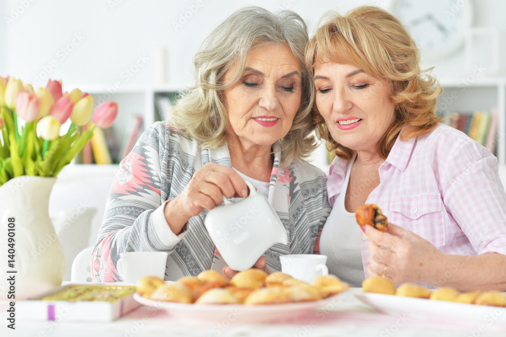 Two beautiful mature women having breakfast