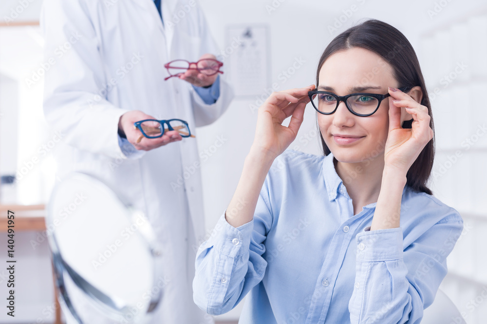 Optician with eyeglasses and client Optician with eyeglasses and client