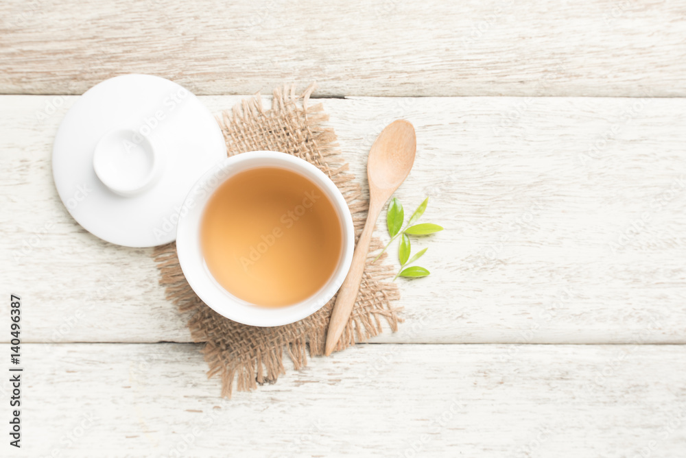 Cup of tea and tea leaves on wooden,top view Cup of tea and tea leaves on wooden,top view