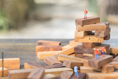 Miniature people : travelers with backpack standing on the top of cactus. Hiking, tourism, exploring the world background concept.
