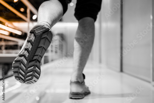 Running sport. Man runner legs and shoes in action at sport shop. Shoot in black and white shop. © usssajaeree