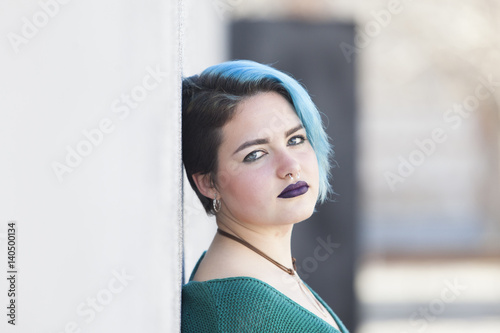 Teen androgynous woman keeping a confindent attitude to her problems photo