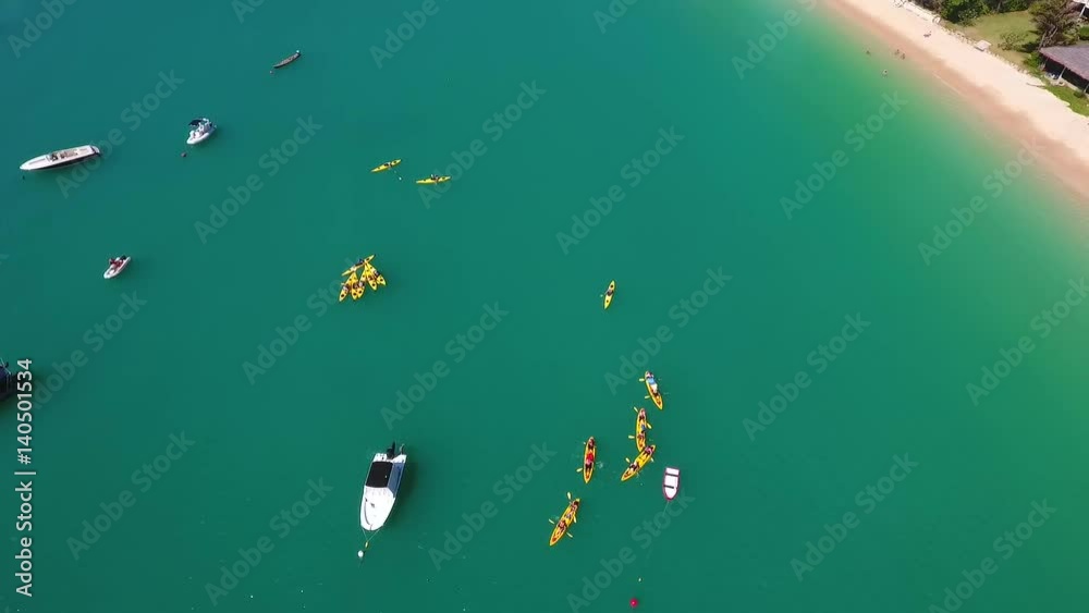 Yellow Kayaks Group on Beautiful Clear Sea Water. HD Aerial View Shot. Phuket, Thailand. Yellow Kayaks Group on Beautiful Clear Sea Water. HD Aerial View Shot. Phuket, Thailand.