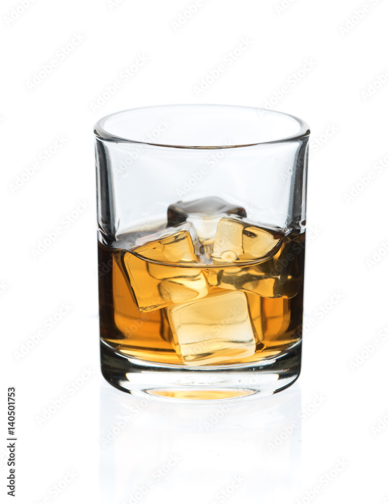 Glass of whisky with ice on a white Glass of whisky with ice on a white