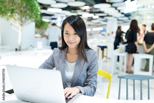 Businesswoman working on notebook computer at co work space Free Download Businesswoman working on notebook computer at co work space - GFXLoad