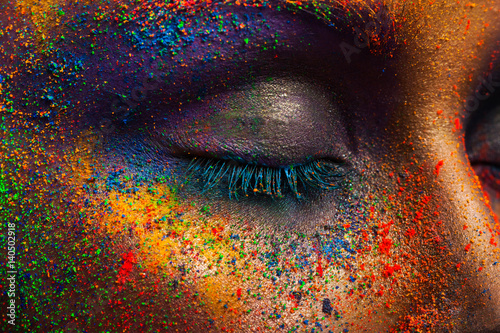 Eye of model with colorful art make-up, close-up