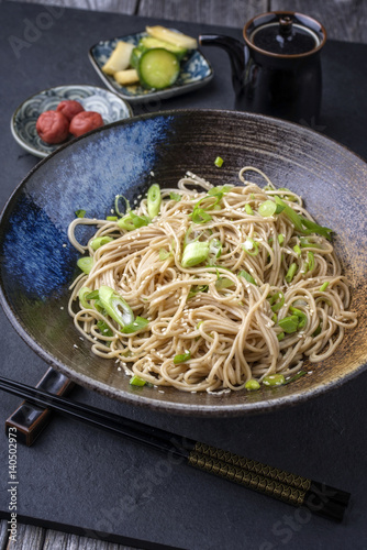 Traditional Japanese Soba Noodles with Tsukemono as close-up in a bowl photo