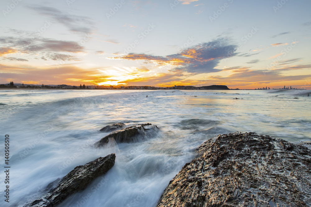 High tide flowing over the rocks during sunset at Currumbin Rock Gold Coast