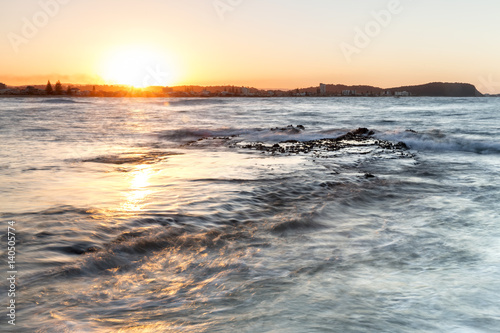 Sunset at Currumbin Rock Gold Coast with ocean tide flowing across the rock © Bostock