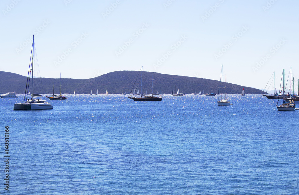 Sail boats (yachts) in front of Bodrum city center. It is sunny summer day.