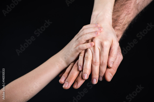 Family stacking hands © LIGHTFIELD STUDIOS