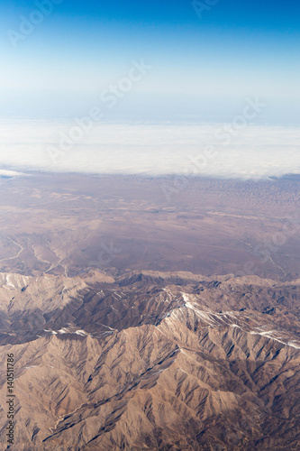 Clouds mountains and sky as seen through window of an aircraft of uzbekistan