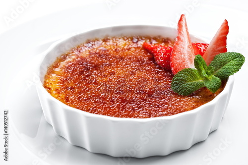 Сreme brulee dessert with mint leaf and strawberry isolated on white 