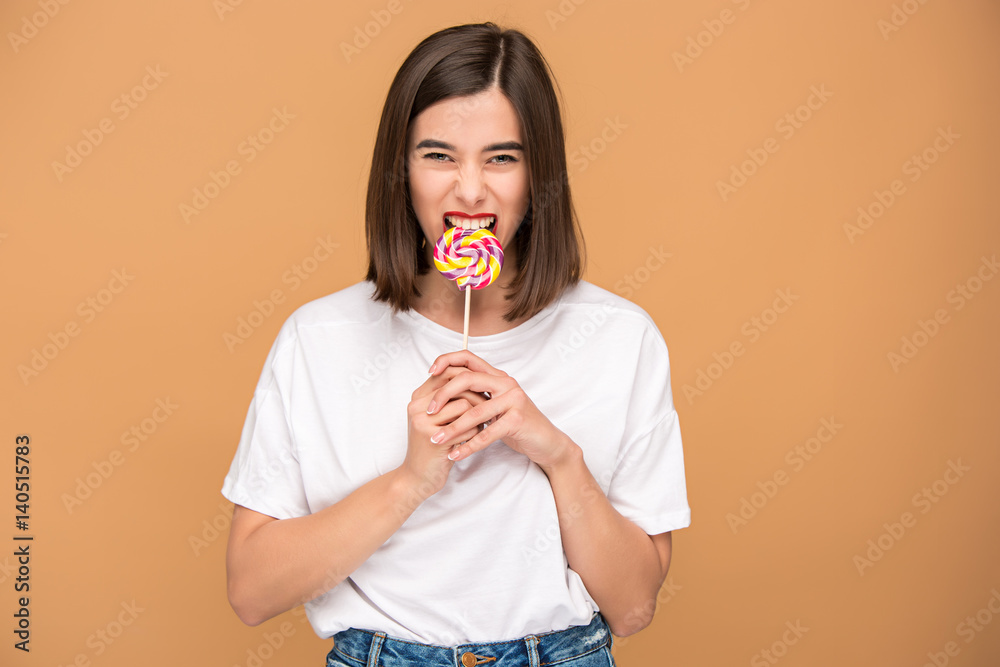 The young woman with colorful lollipop The young woman with colorful lollipop