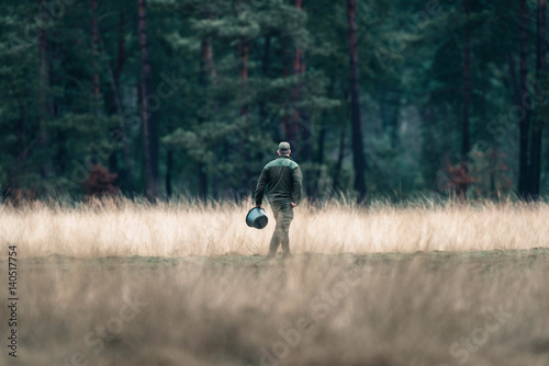 Billede på lærred Rangers with feeding bucket in field. National Park Hoge Veluwe.