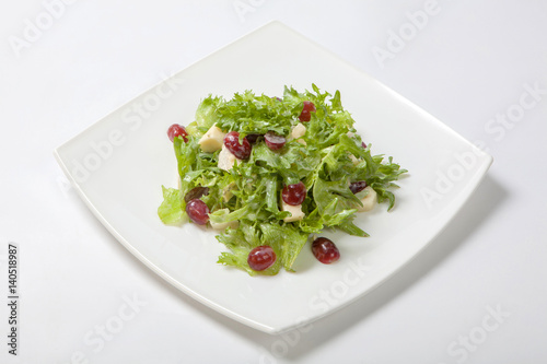 Fresh salad of lettuce with sweet sauce with pieces of fruit