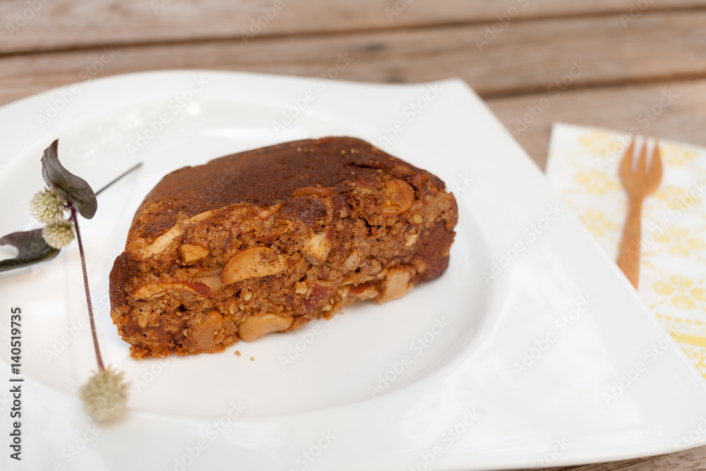 Banana cake with almonds on white plate Banana cake with almonds on white plate