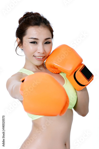 Sexy asian young women slim fit wearing orange mitt boxing on white Studio Background