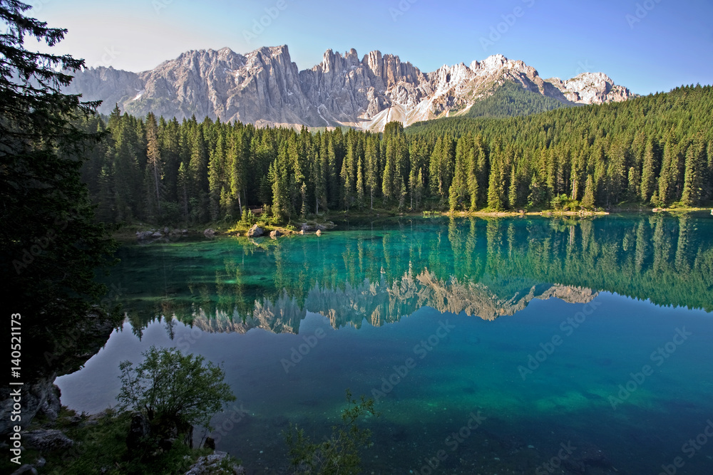 Lago di Carezza, an extremely clear lake in the Dolomites of Northern Italy. Visibility more than 30 feet down to see logs, fish and sand. Also known as Rainbow Lake.