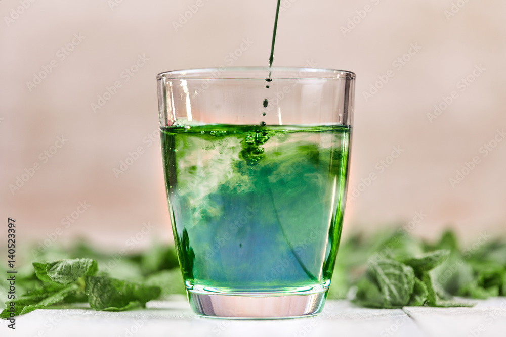 Green chlorophyll drink in glass with water - obrazy, fototapety, plakaty 