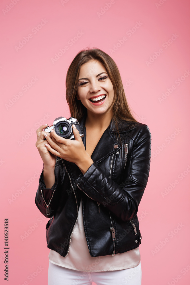 Smiling hipster femal in casual outfit hold old camera Smiling hipster femal in casual outfit hold old camera