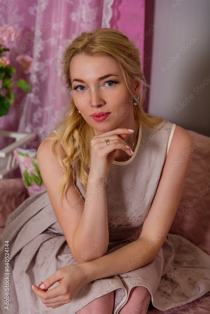 Portrait of a cute young blonde in a beautiful short dress Portrait of a cute young blonde in a beautiful short dress