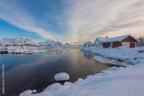 Norway in winter  mountains with colorful houses and the ocean on a sunny winter day in Lofoten islands